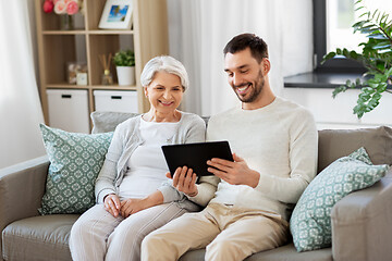 Image showing old mother and adult son with tablet pc at home