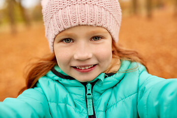 Image showing happy girl taking selfie at autumn park