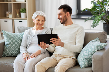 Image showing old mother and adult son with tablet pc at home