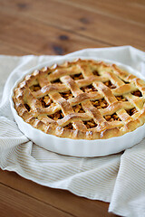 Image showing close up of apple pie in mold on wooden table