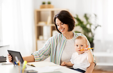 Image showing working mother with tablet pc and baby at home