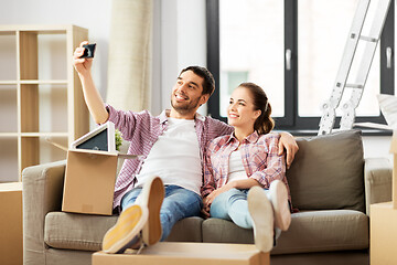 Image showing couple taking selfie by smartphone at new home