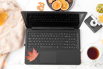 Image showing laptop, tea, camera, autumn leaves and sweater