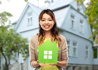 Image showing happy asian woman with green house