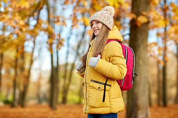 Image showing happy student girl with schoolbag at autumn park
