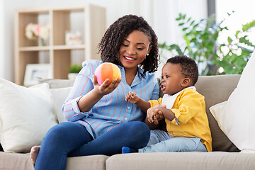 Image showing mother and baby playing with ball at home