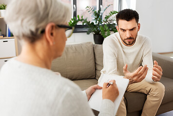 Image showing senior woman psychologist and sad man patient