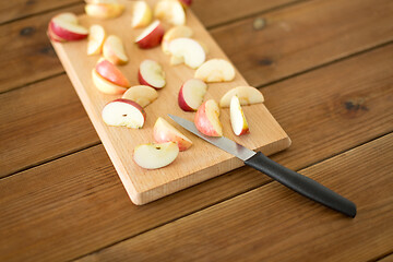 Image showing sliced apples and knife on wooden cutting board