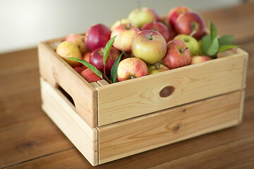 Image showing ripe apples in wooden box on table