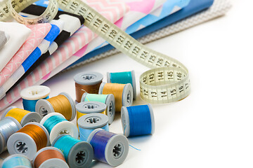 Image showing cotton fabric material, tailor measurement tape and spools of co