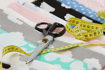 Image showing cotton fabric material, tailor measurement tape and scissors