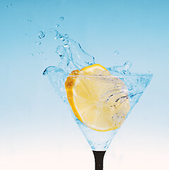 Image showing fresh lemon in glass with water splash