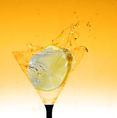 Image showing fresh lemon in glass with water splash