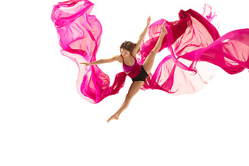 Image showing Ballerina. Young graceful female ballet dancer dancing over white studio. Beauty of classic ballet.