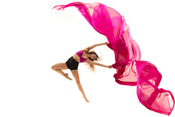 Image showing Ballerina. Young graceful female ballet dancer dancing over white studio. Beauty of classic ballet.