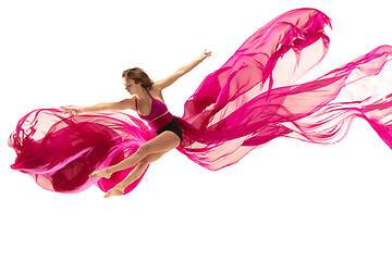 Image showing Ballerina. Young graceful female ballet dancer dancing over white studio. Beauty of classic ballet.