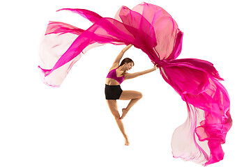 Image showing Ballerina. Young graceful female ballet dancer dancing over white studio. Beauty of classic ballet.