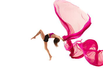 Image showing Ballerina. Young graceful female ballet dancer dancing over white studio. Beauty of classic ballet.