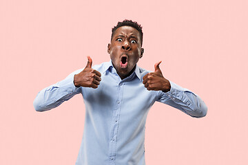 Image showing The happy businessman standing and smiling against pink background.