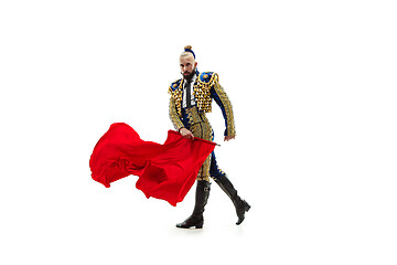 Image showing Torero in blue and gold suit or typical spanish bullfighter isolated over white