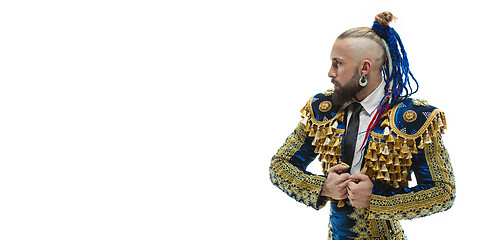 Image showing Torero in blue and gold suit or typical spanish bullfighter isolated over white