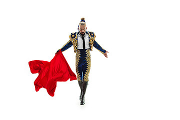 Image showing Torero in blue and gold suit or typical spanish bullfighter isolated over white