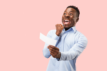 Image showing Young boy with a surprised expression bet slip on blue background