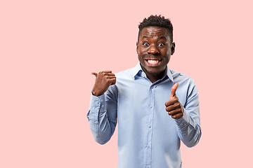 Image showing The happy businessman standing and smiling against pink background.