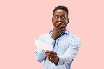 Image showing Young boy with a surprised expression bet slip on pink background