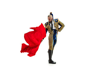 Image showing Torero in blue and gold suit or typical spanish bullfighter isolated over white