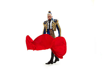 Image showing Torero in blue and gold suit or typical spanish bullfighter isolated over white