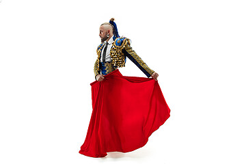 Image showing Torero in blue and gold suit or typical spanish bullfighter isolated over white