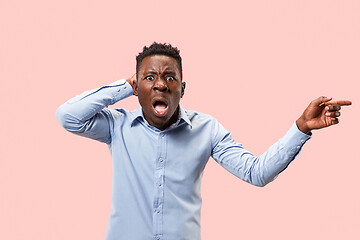 Image showing The young attractive man looking suprised isolated on pink