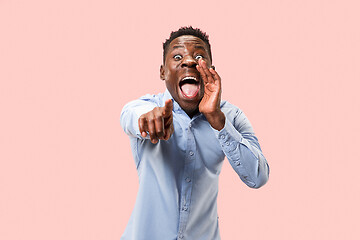 Image showing Isolated on pink young casual man shouting at studio