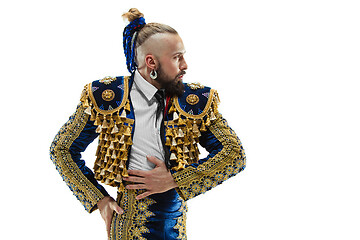 Image showing Torero in blue and gold suit or typical spanish bullfighter isolated over white