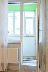 Image showing Exit to a glazed balcony from a room in a multi-storey building