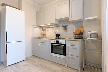 Image showing Kitchen layout, fridge and direct kitchen with hanging cupboards