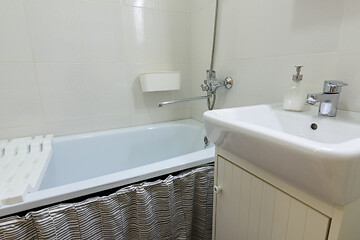 Image showing Small budget bathroom with a small washbasin