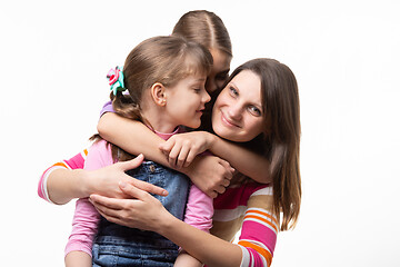 Image showing Two sisters and mom are hugging happily, isolated on white background