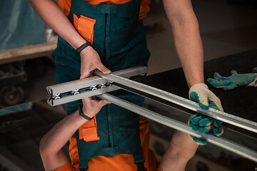 Image showing Worker cutting the surface of glass mirror