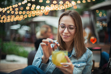 Image showing Woman with cocktail at cafe outdoor.