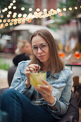 Image showing Woman with cocktail at cafe outdoor.