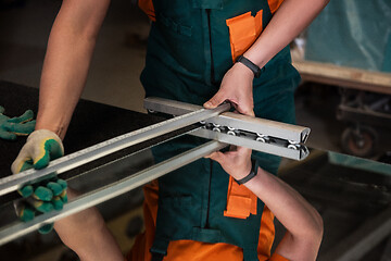 Image showing Worker cutting the surface of glass mirror