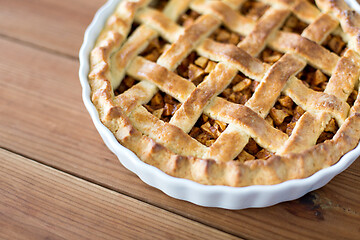 Image showing close up of apple pie in mold on wooden table