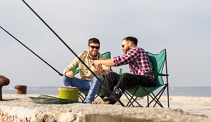 Image showing friends with smartphone fishing and drinking beer