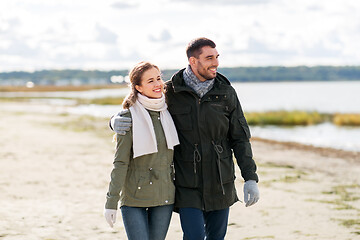 Image showing couple walking along autumn beach