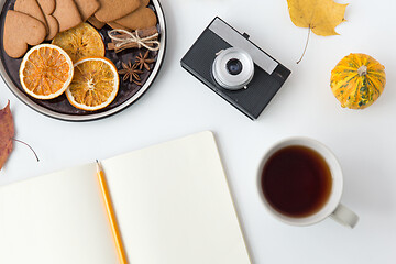 Image showing notebook, hot chocolate, camera and autumn leaves