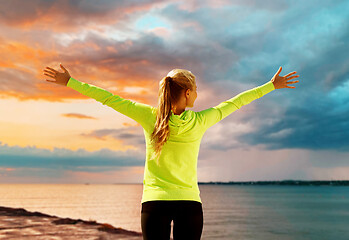 Image showing happy woman in sports clothes at seaside