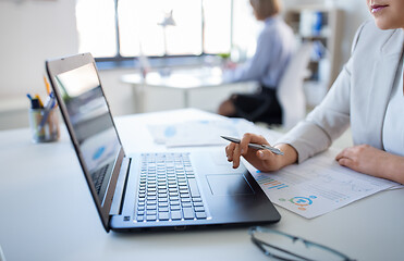 Image showing businesswoman with laptop working at office