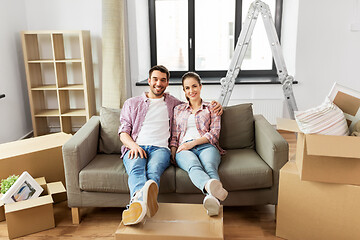 Image showing happy couple with boxes moving to new home